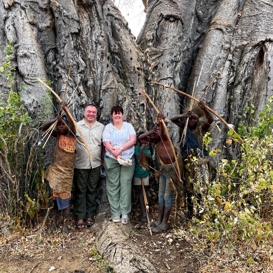A photograph taken together during our visit with the Hadzabe, in the bush near Lake Eyasi
